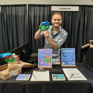 Aaron holding our shark skull kit model at our conference booth